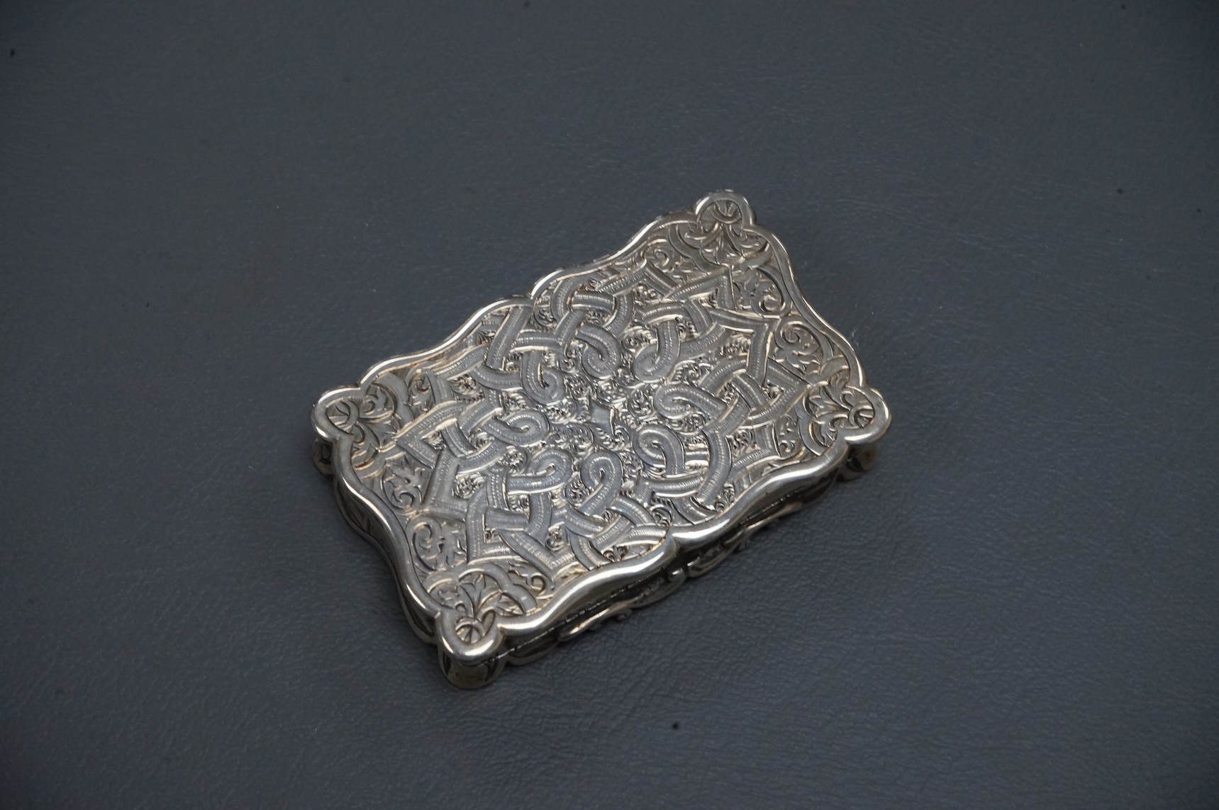 A Victorian engraved silver shaped rectangular snuff box, by George Unite, Birmingham, 1867, 7cm.